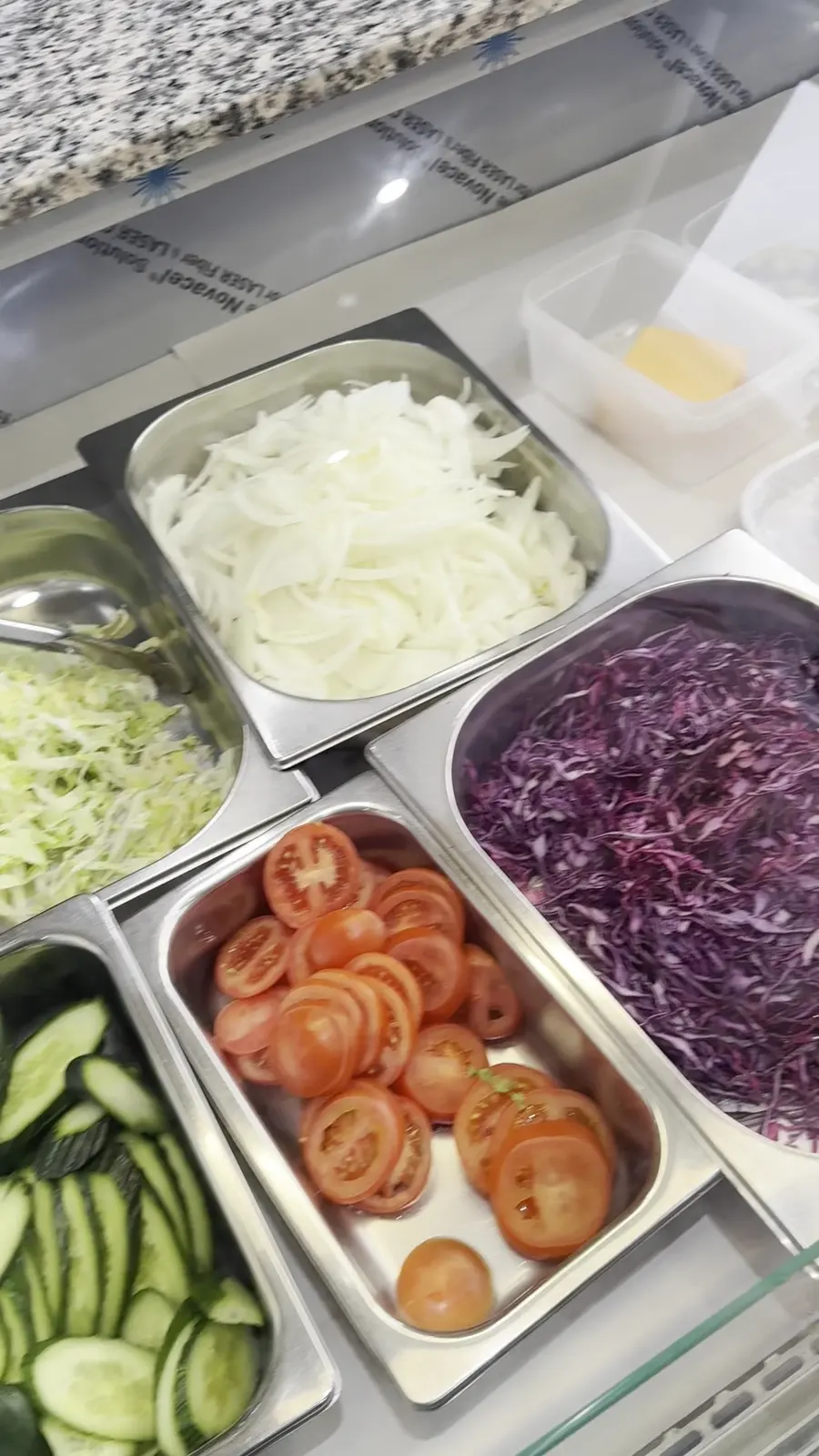 Fresh salad tray on the kebab counter: lettuce, cabbage, onion, tomato and cucumber
