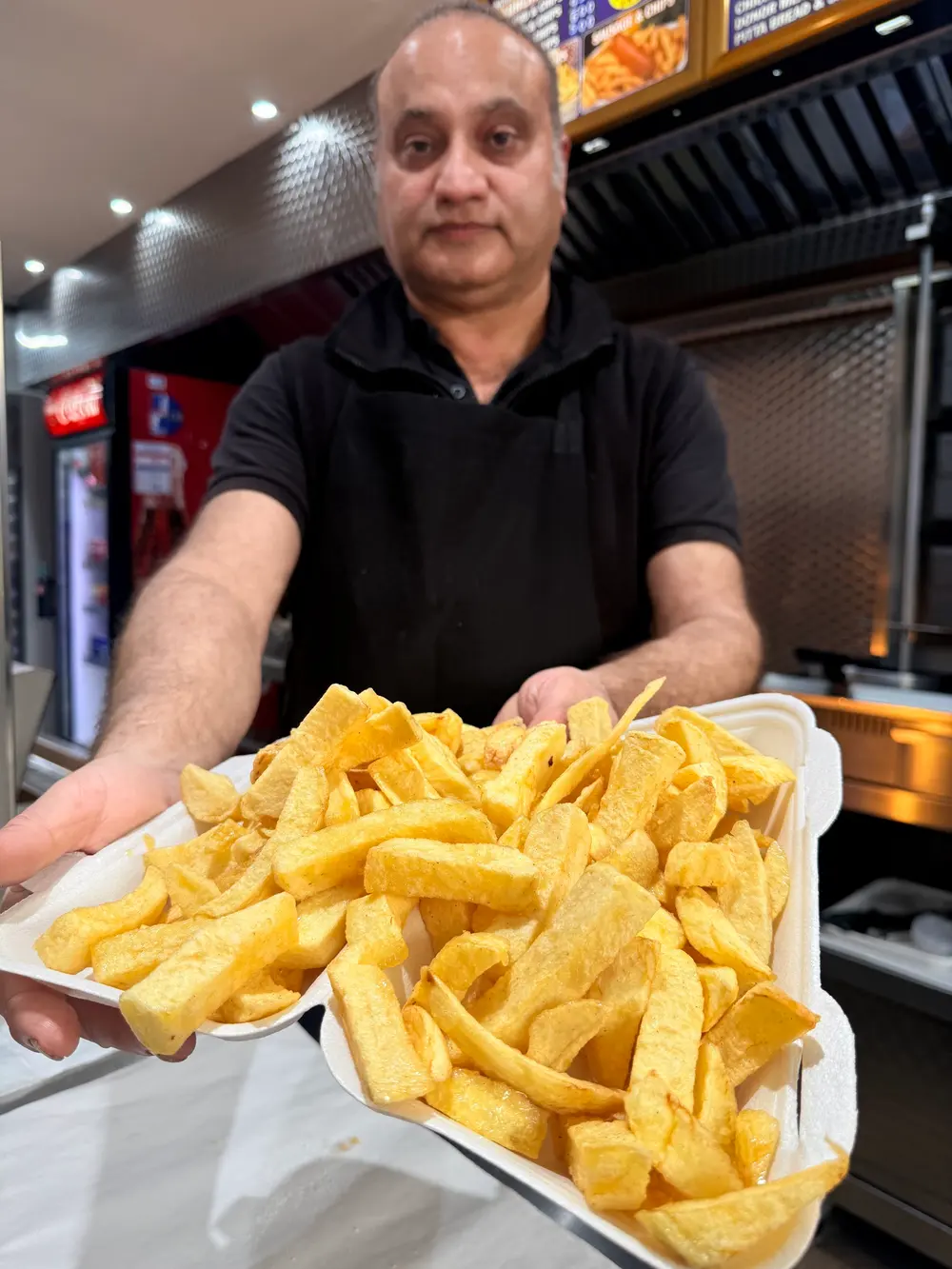 Tony holding a tray of freshly cooked chips
